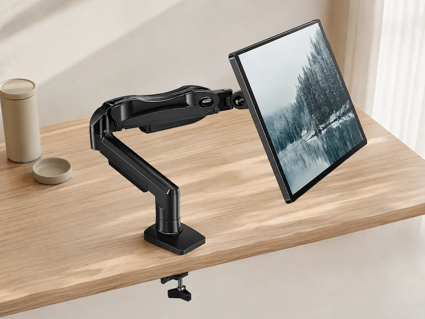 High-angle view of the monitor arm and desk mounting area