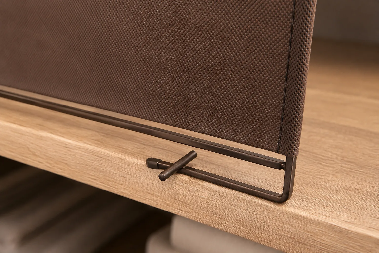 Close-up of the bronze U-hook and locking bar gripping the shelf edge