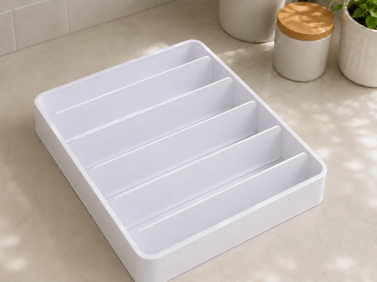 Empty lid organizer showing adjustable dividers and slots
